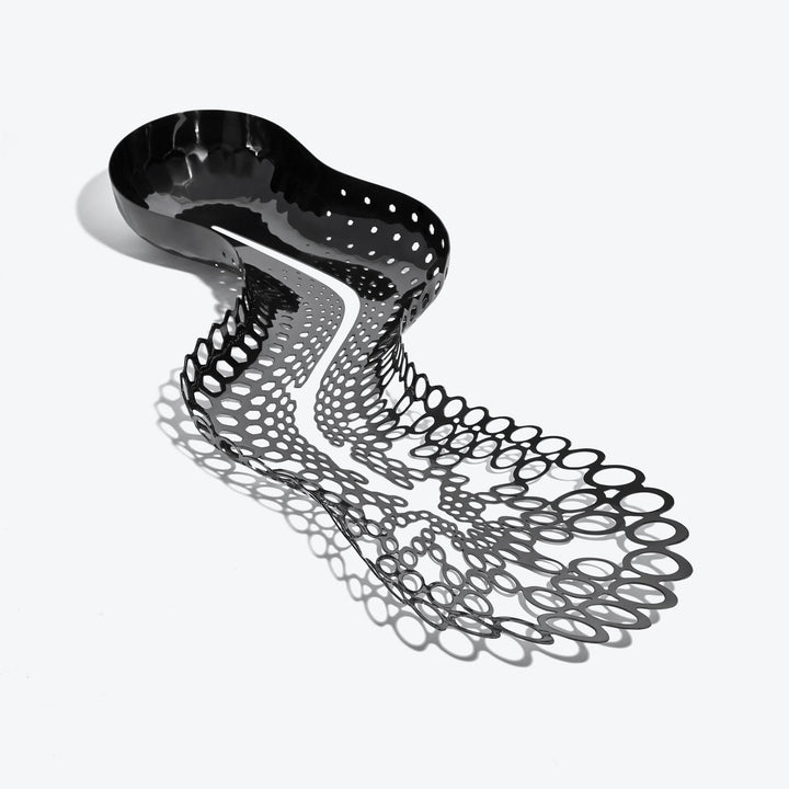 Cell Centerpiece — black stainless steel centerpiece seen from above, bowl tapering into open cells