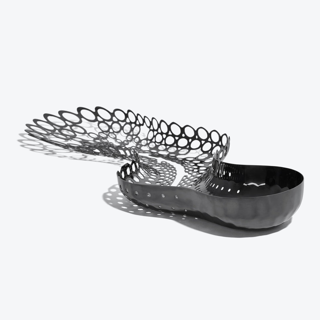 Cell Centerpiece — black stainless steel centerpiece, solid bowl end flowing into a perforated cell pattern