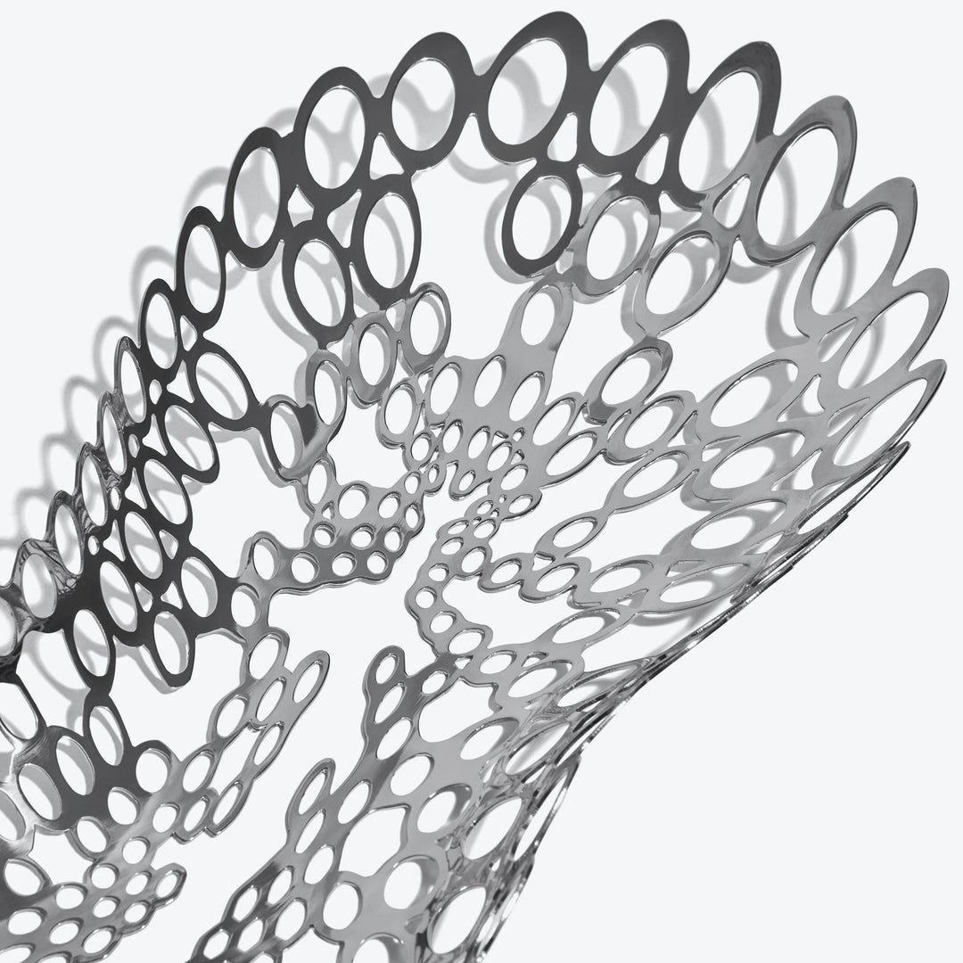 Cell Centerpiece — close-up of the silver perforated cell pattern and its shadows