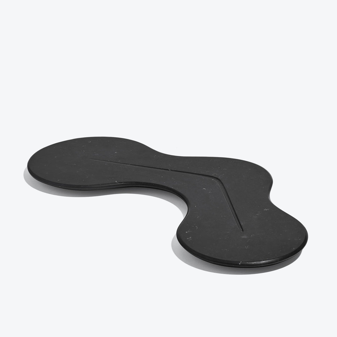 Cell Platter — black marble platter, three-quarter view showing the carved line