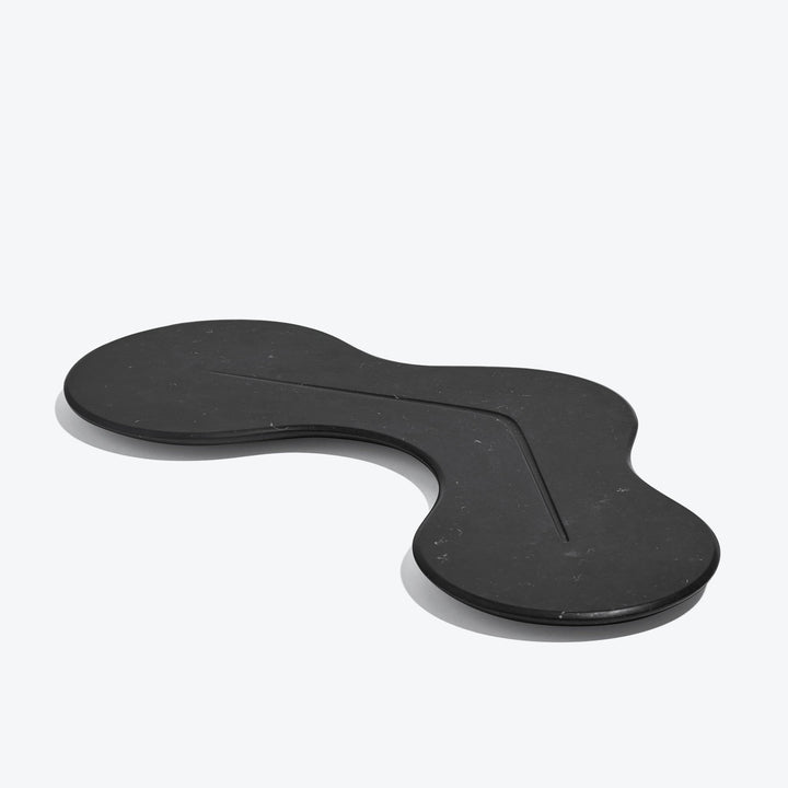 Cell Platter — black marble platter, three-quarter view showing the carved line