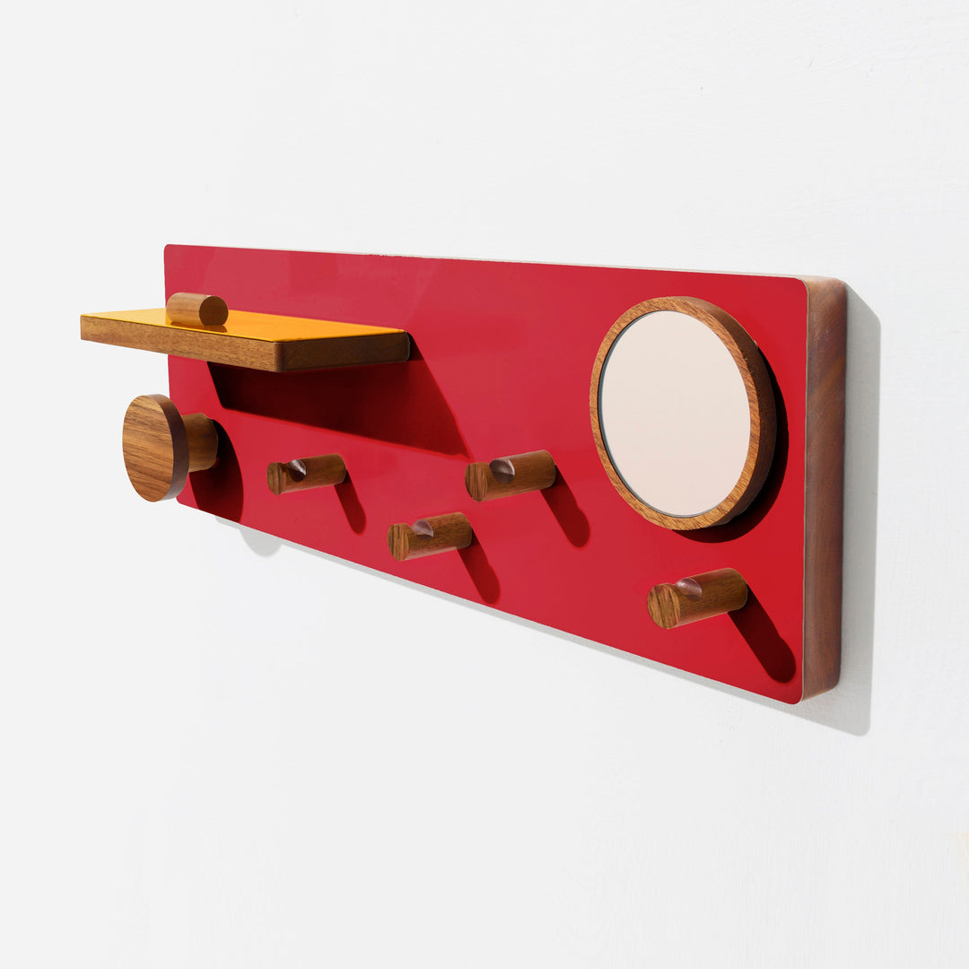 Modern red lacquered wood wall organizer with mirror, pegs, and floating shelf