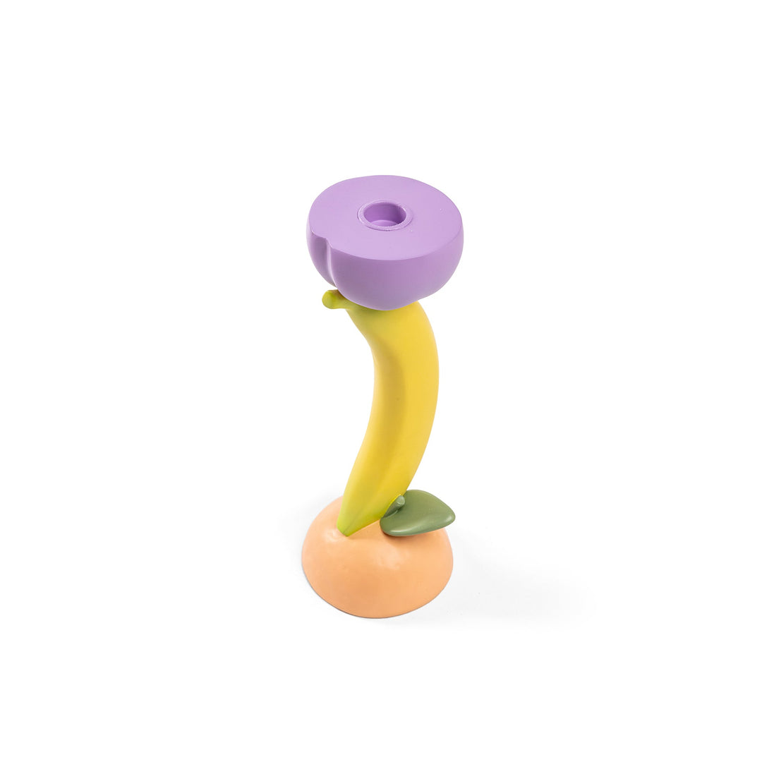Seletti Vitamin Banana Candlestick, angled view of the purple cup and curved banana