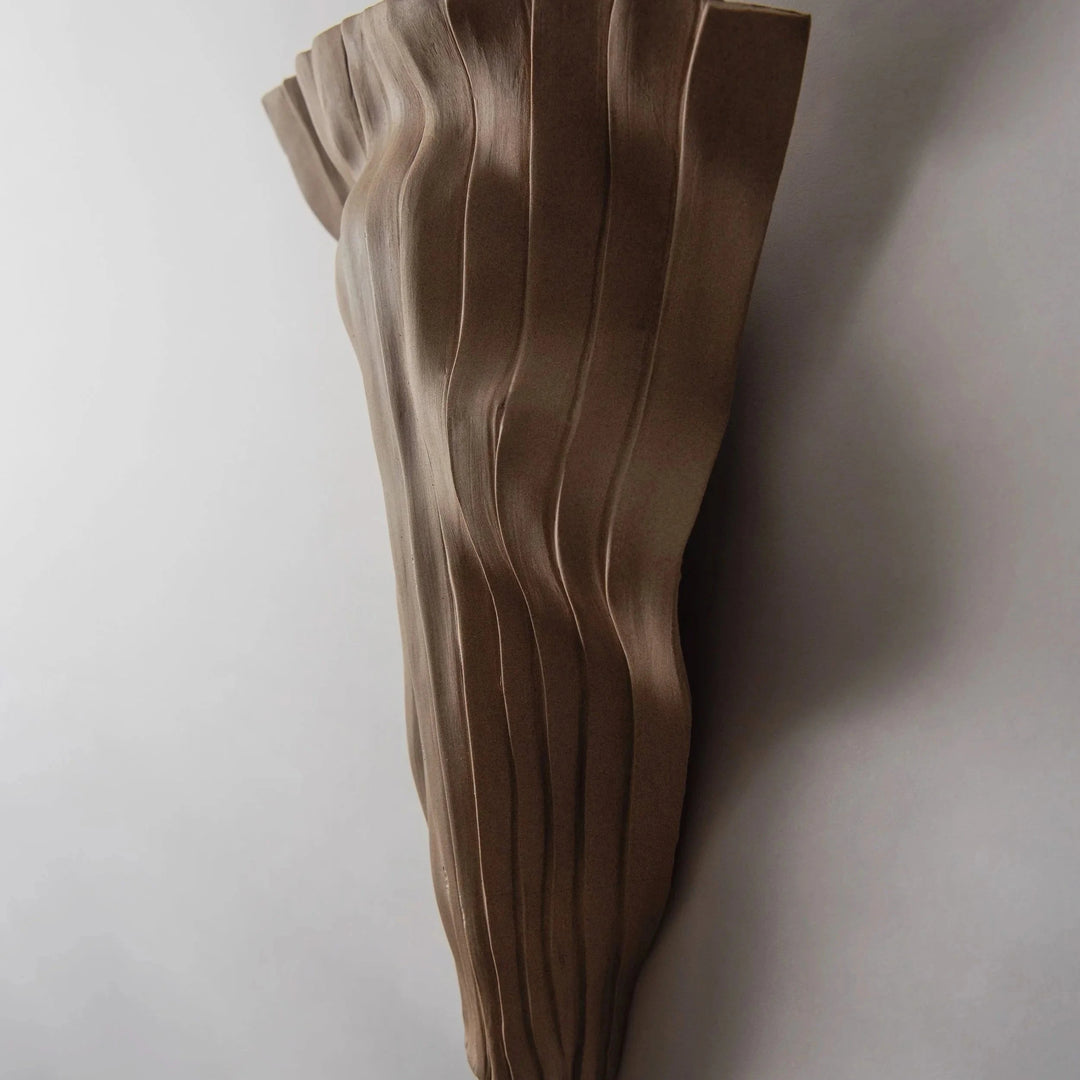 Tenderness Ceramic Wall Sconce — Toffee Stoneware, tall elongated silhouette, front view illuminated