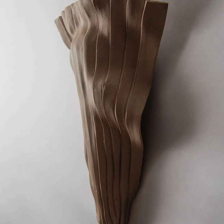 Tenderness Ceramic Wall Sconce — Toffee Stoneware, tall elongated silhouette, front view illuminated