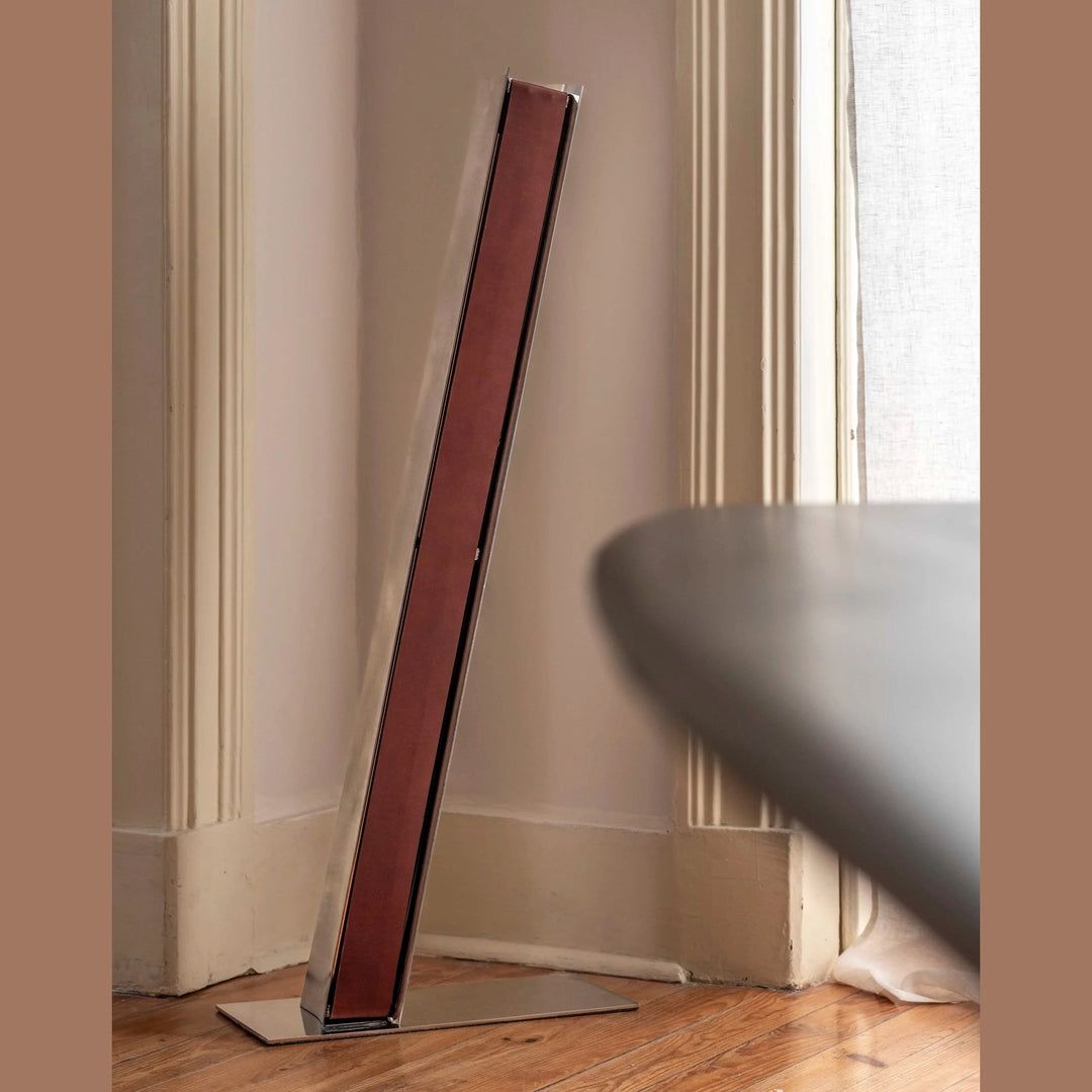 Impermanence Stainless Steel &amp; Leather Floor Light — Brown leather, lifestyle shot leaning in a room corner