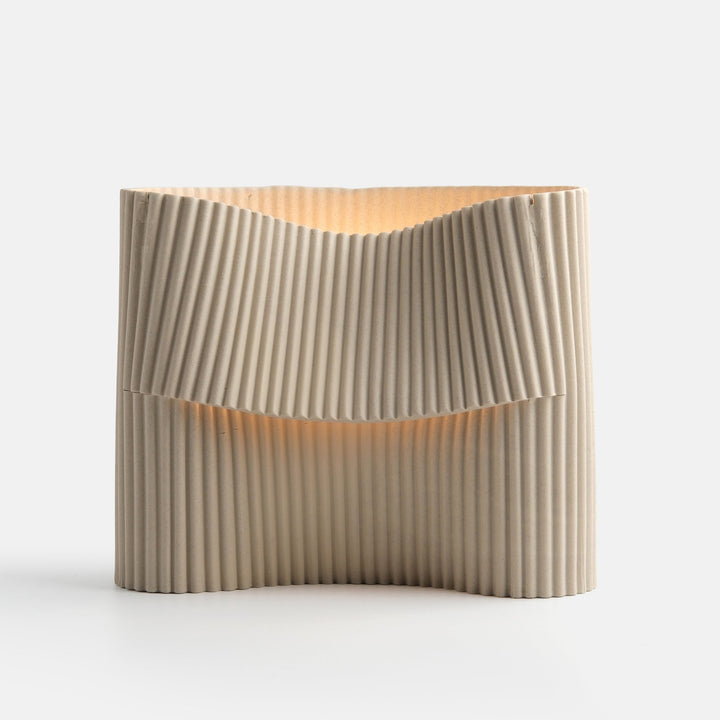 Rippled ceramic vase with warm glow, elegant home decor