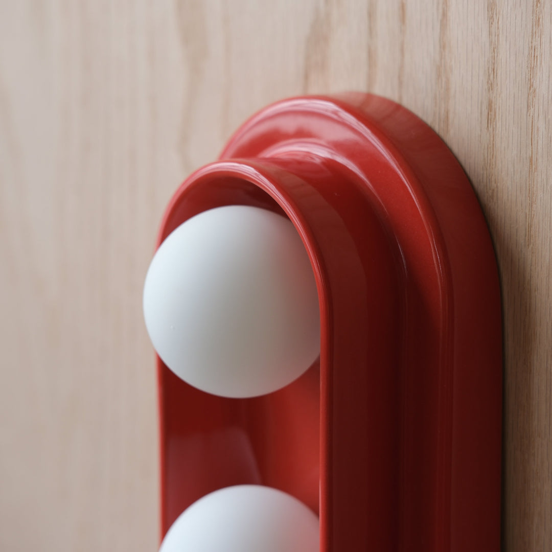Glossy red ceramic egg holder with white eggs, modern kitchen decor