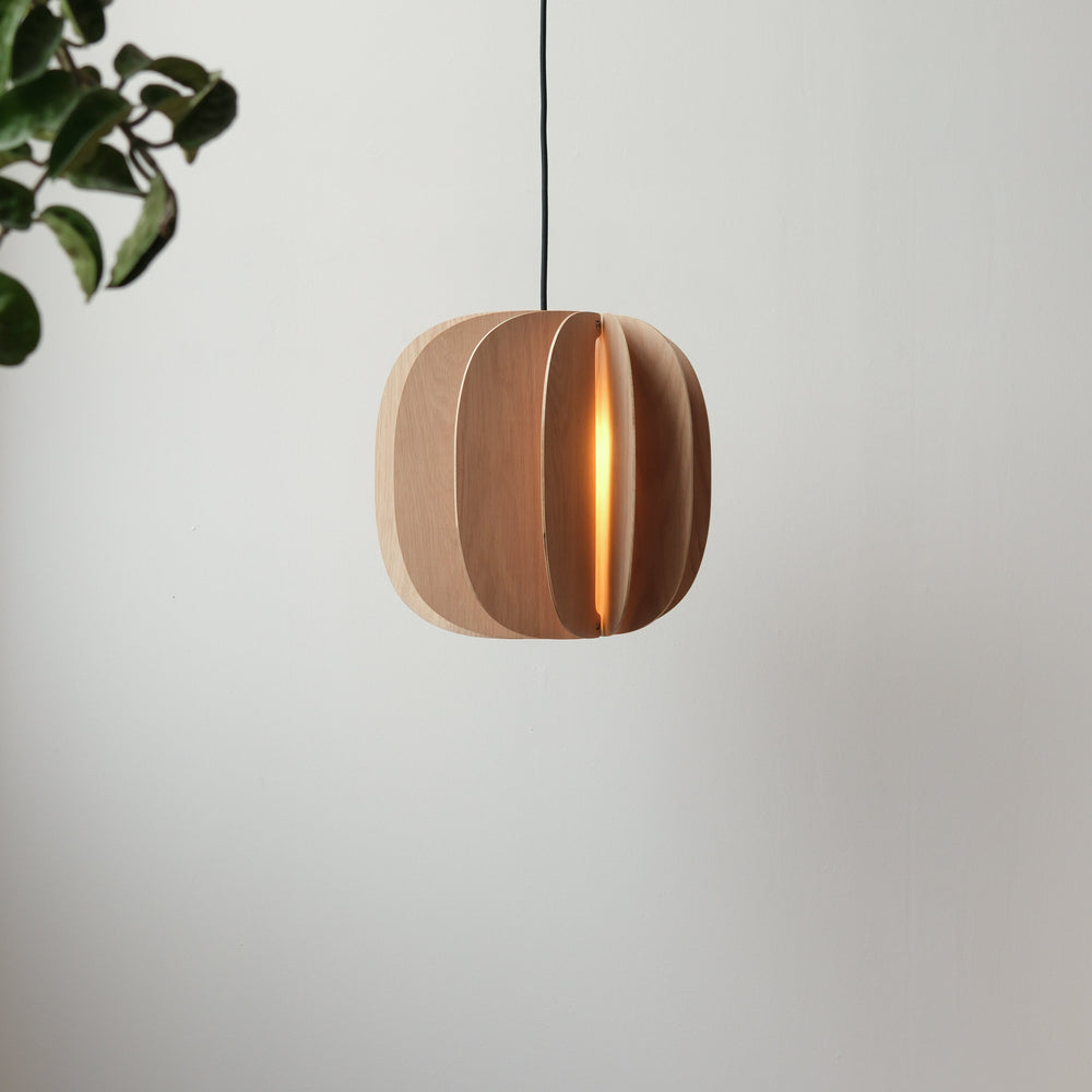 Modern wood pendant light with warm glow, sleek layered design