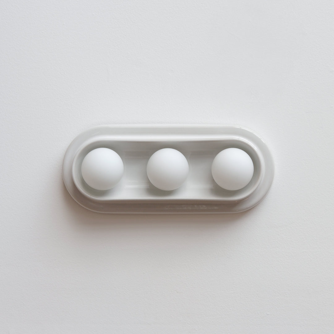 Minimalist white ceramic tray with three spherical accents, modern home decor