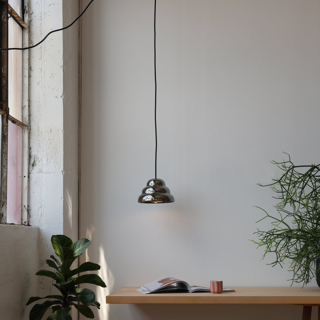 Brass pendant light with tiered design, modern minimalist decor