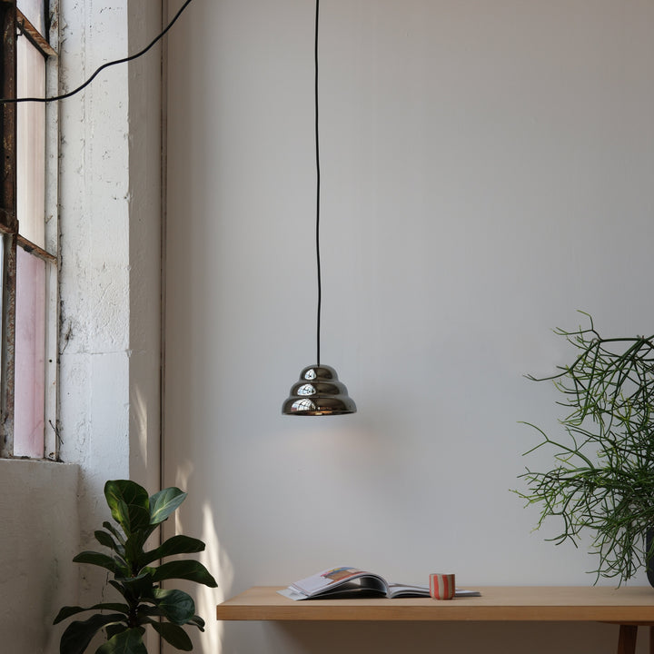 Brass pendant light with tiered design, modern minimalist decor