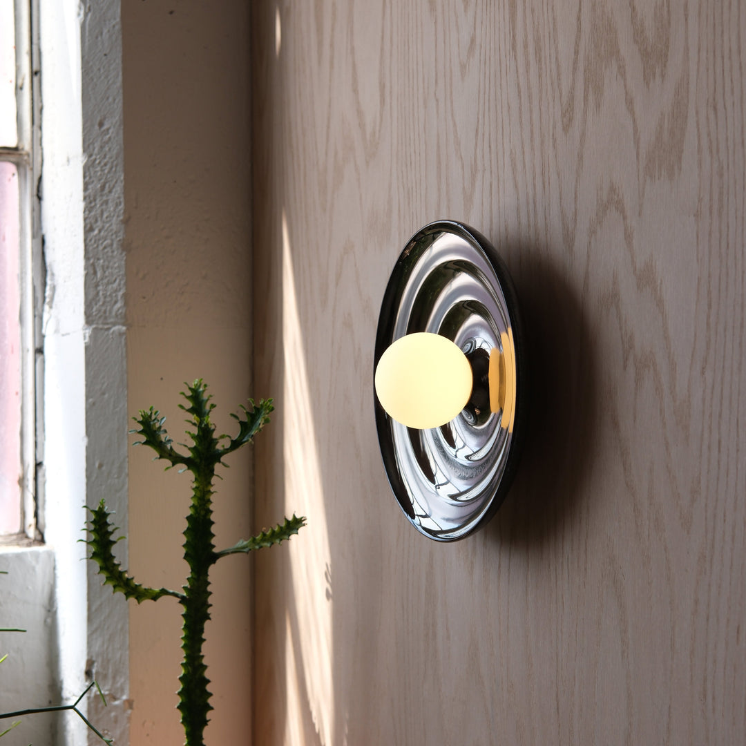 Chrome wall sconce with frosted globe, modern designer lighting