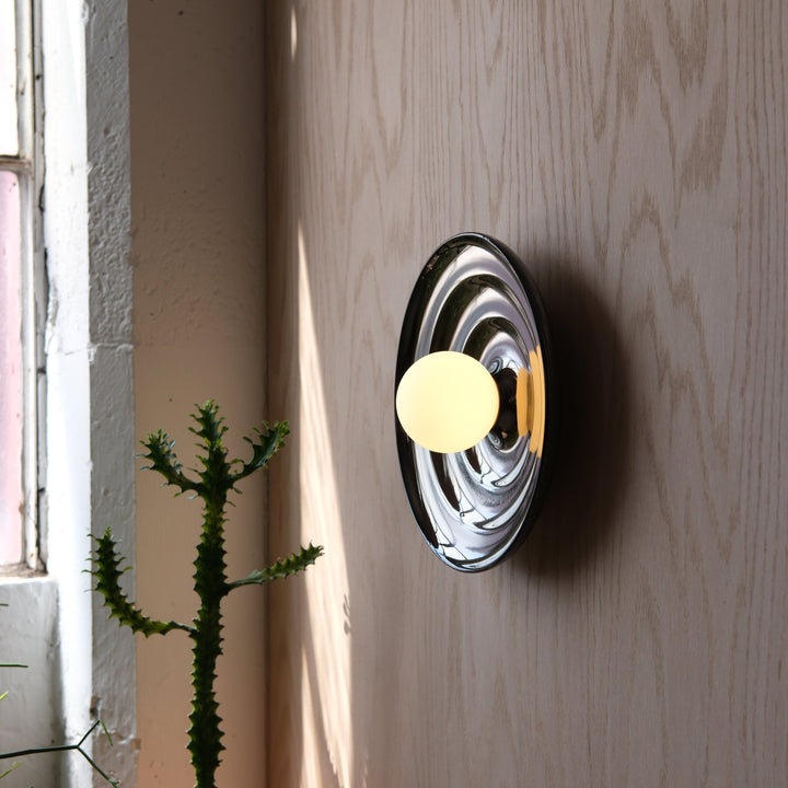 Chrome wall sconce with frosted globe, modern designer lighting