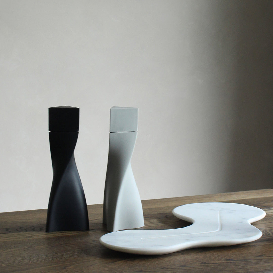 Cell Platter — white marble platter on a wooden table beside black and grey Duo salt and pepper mills