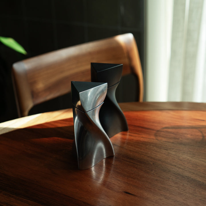Duo Mini Salt and Pepper Grinder Set — Silver &amp; Black grinders on a walnut table, lifestyle