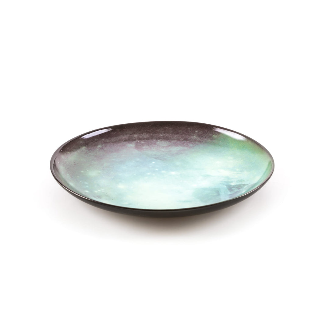 Seletti Cosmic Diner Pluto Dinner Plate, angled view of the pale green and mauve print