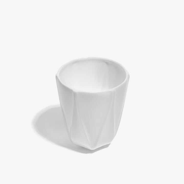 Folio Vessel, Set of 4 — large white faceted vessel, high three-quarter view into the rim on a white background