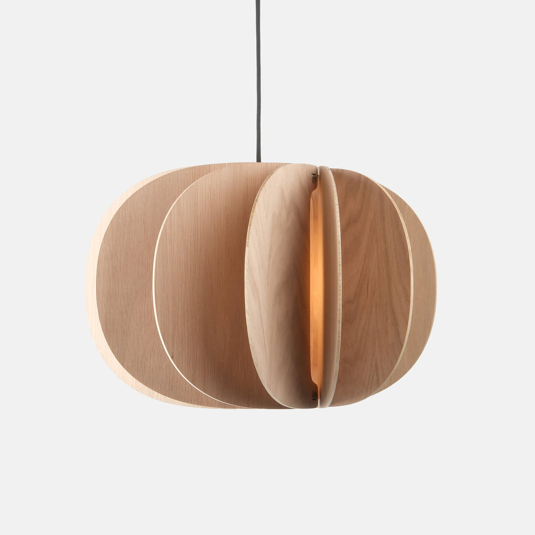 Sculptural oak pendant light with layered circular design, emitting warm ambient glow
