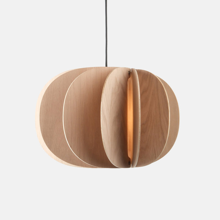 Sculptural oak pendant light with layered circular design, emitting warm ambient glow