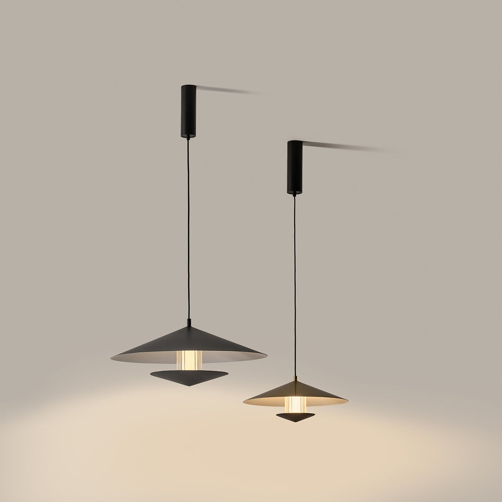 Gehit Pendant Lamp, Large (Ø23.6 in), lit in black beside a smaller gold pendant, casting warm light