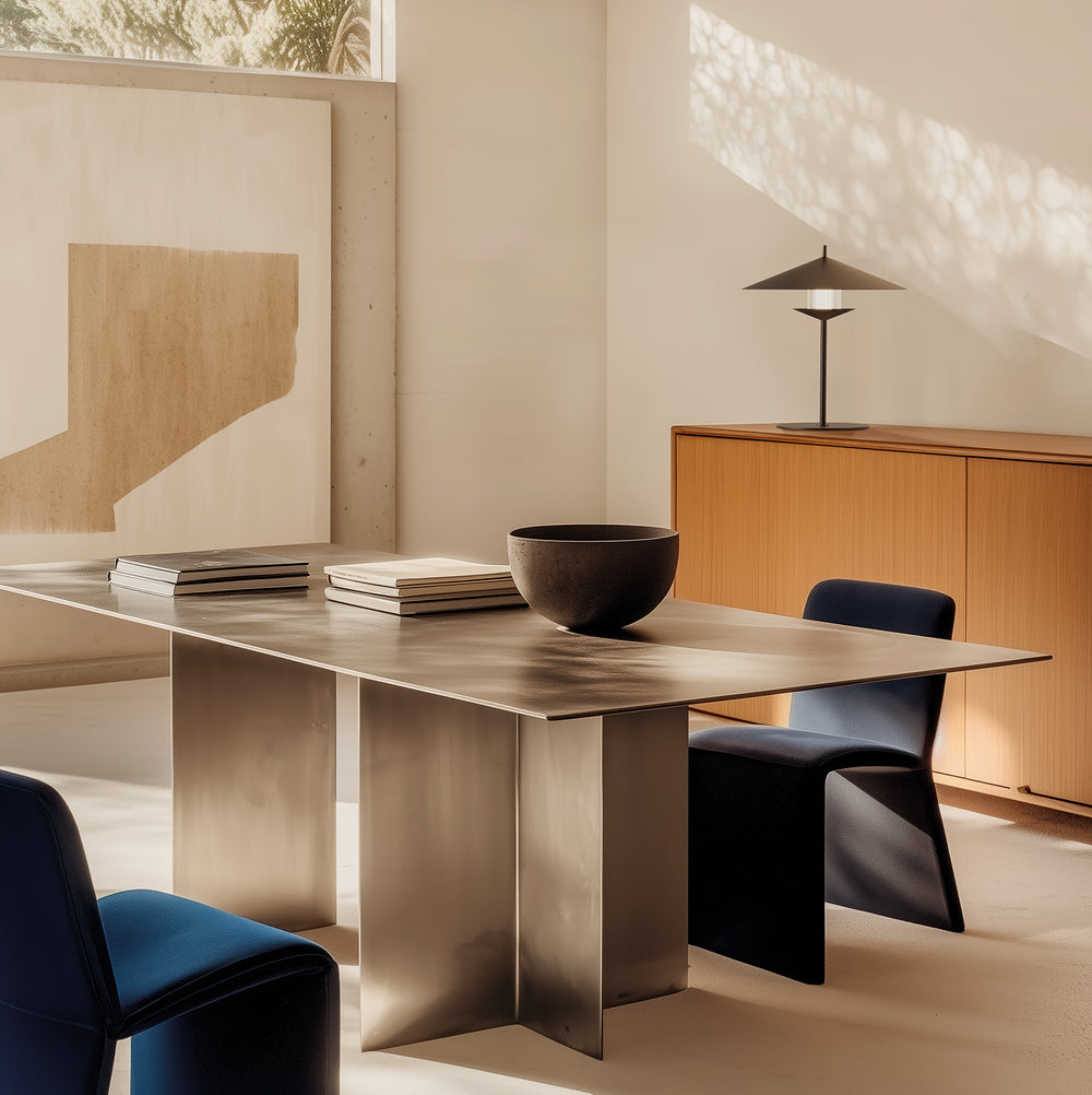 Gehit Table Lamp in black on a wooden sideboard beside a metal dining table and navy chairs