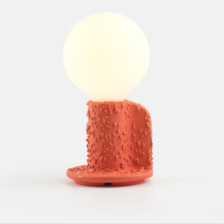 Terracotta textured table lamp with glowing orb shade, modern designer lighting