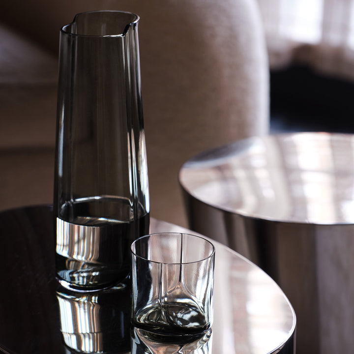 Hew Carafe — Smoke carafe with water and a tumbler on a polished steel side table