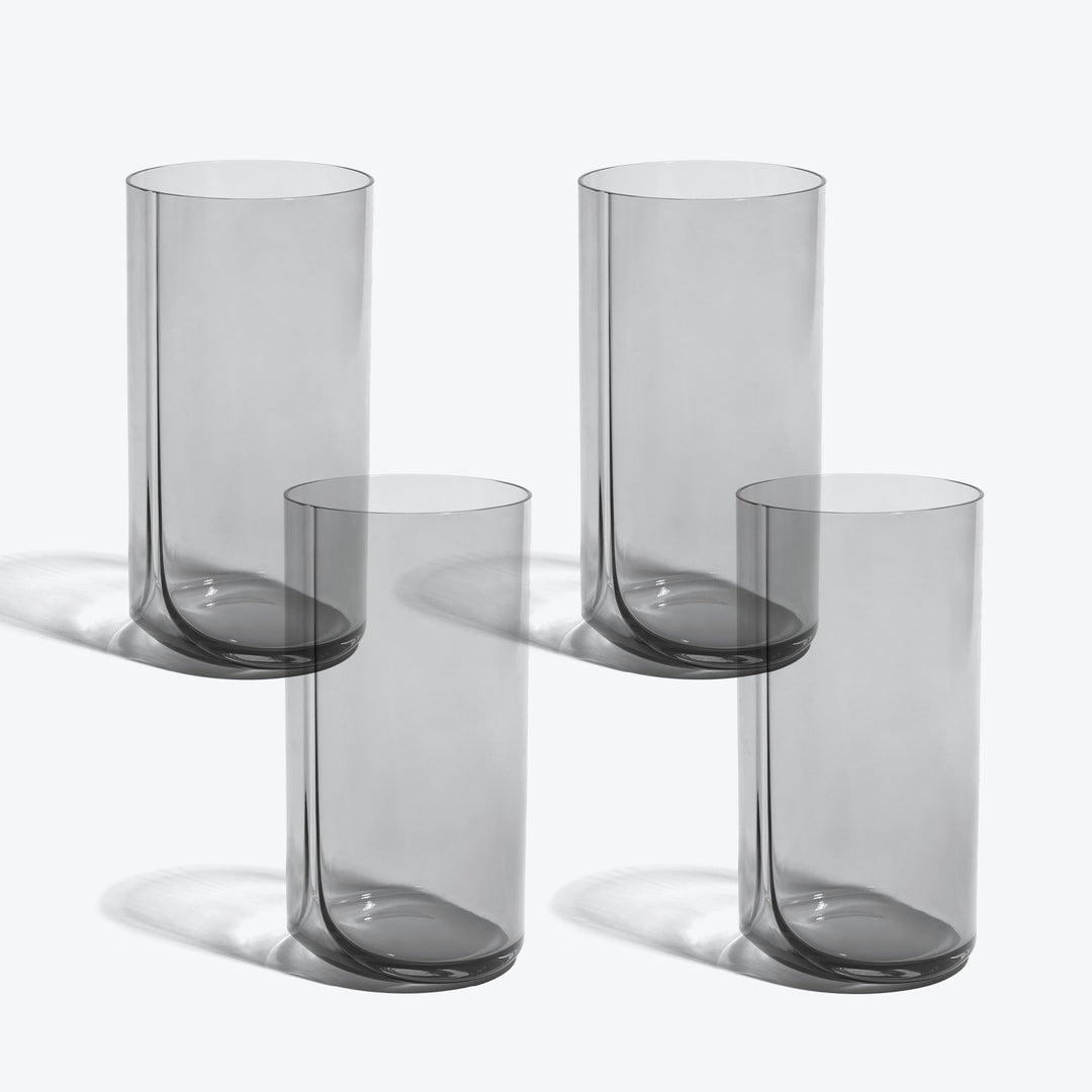 Hew Highball Glass, Set of 4 — four smoke-tinted highball glasses arranged in two rows