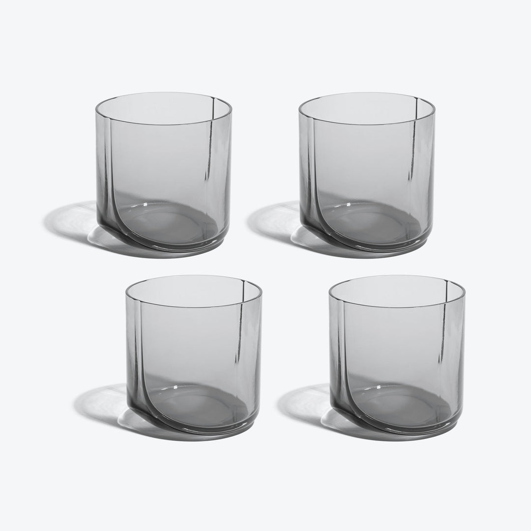 Hew Tumbler, Set of 4 — four Smoke glass tumblers arranged in two rows on white