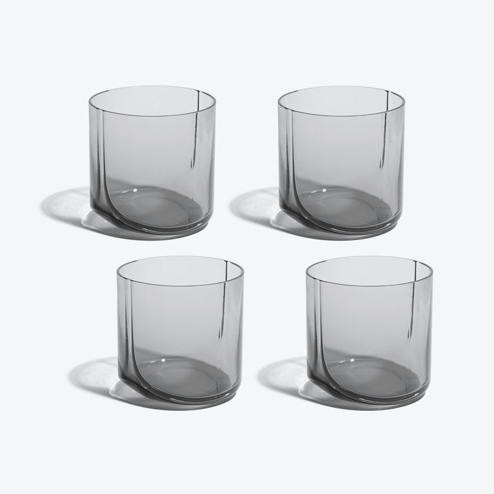 Hew Tumbler, Set of 4 — four Smoke glass tumblers arranged in two rows on white