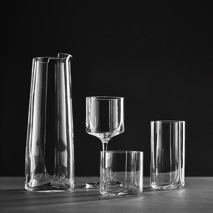 Hew Tumbler, Set of 4 — clear Hew glassware with carafe, wine glass and tumblers against a black backdrop