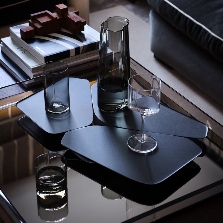 Hew Serving Tray — dark tray holding a Smoke carafe and glassware on a coffee table, close crop