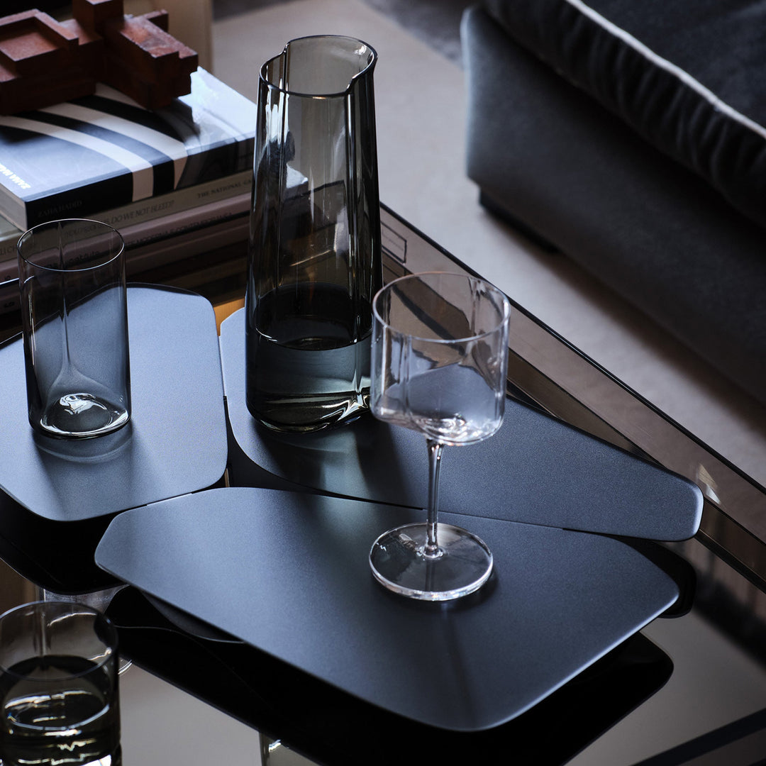 Hew Serving Tray — dark tray with Smoke carafe and clear glasses on a glass coffee table