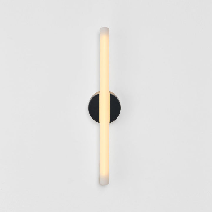 Modern wall sconce with frosted glass and matte black base, minimalist design for elegant interiors