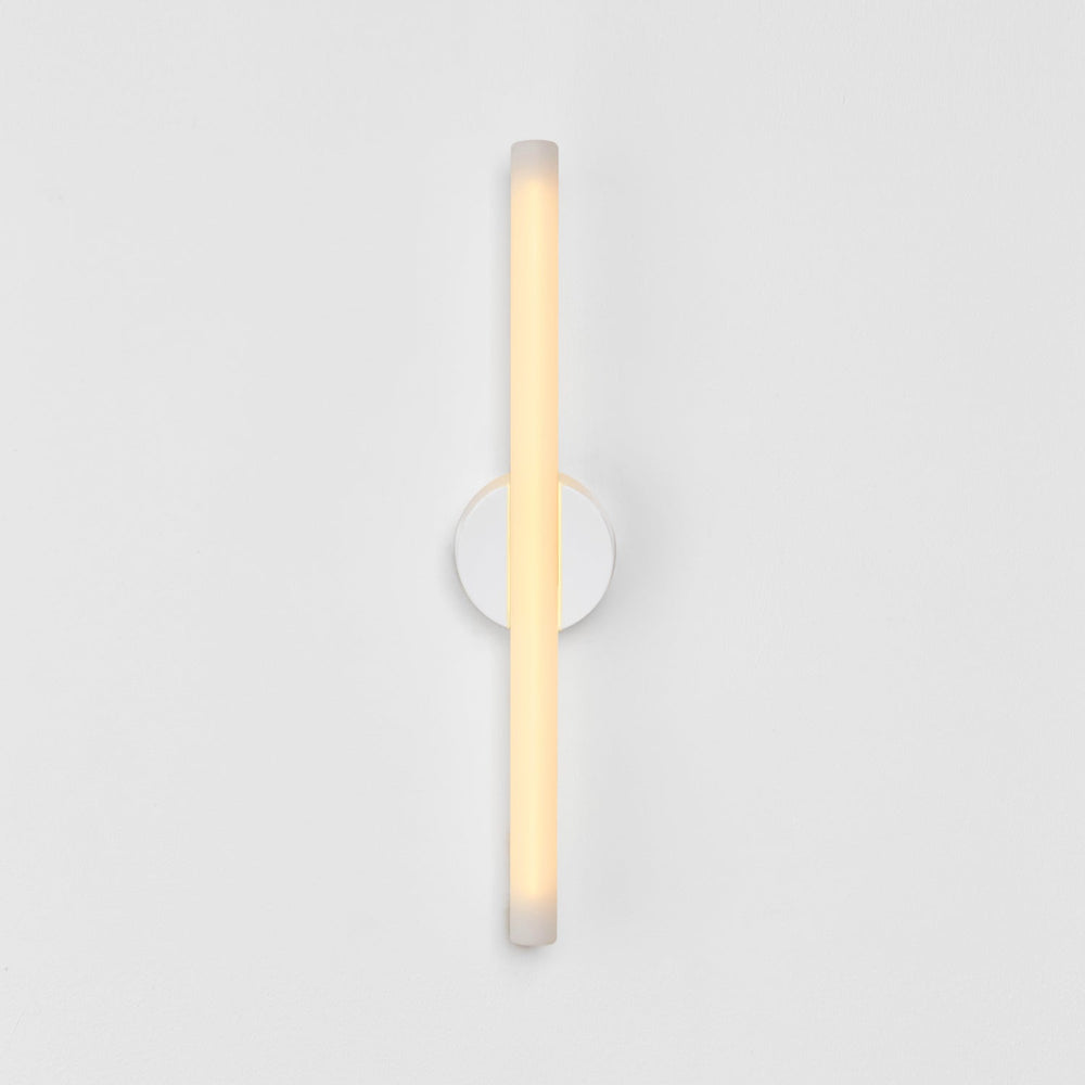 Minimalist frosted glass wall sconce with warm ambient glow, modern designer lighting for contemporary interiors