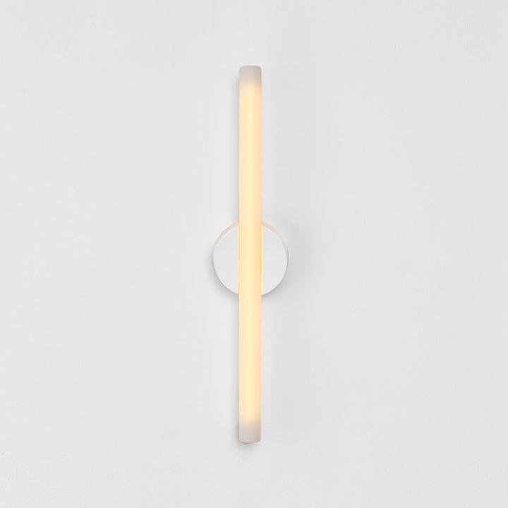 Minimalist frosted glass wall sconce with warm ambient glow, modern designer lighting for contemporary interiors