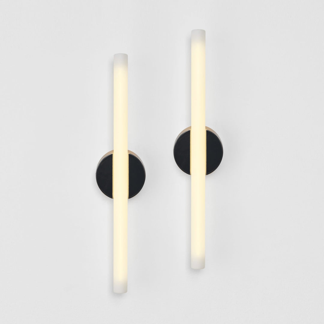 Modern wall sconces with frosted glass and matte black circular mounts