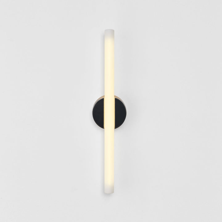 Modern wall sconce with frosted glass and matte black base, minimalist design for elegant interiors