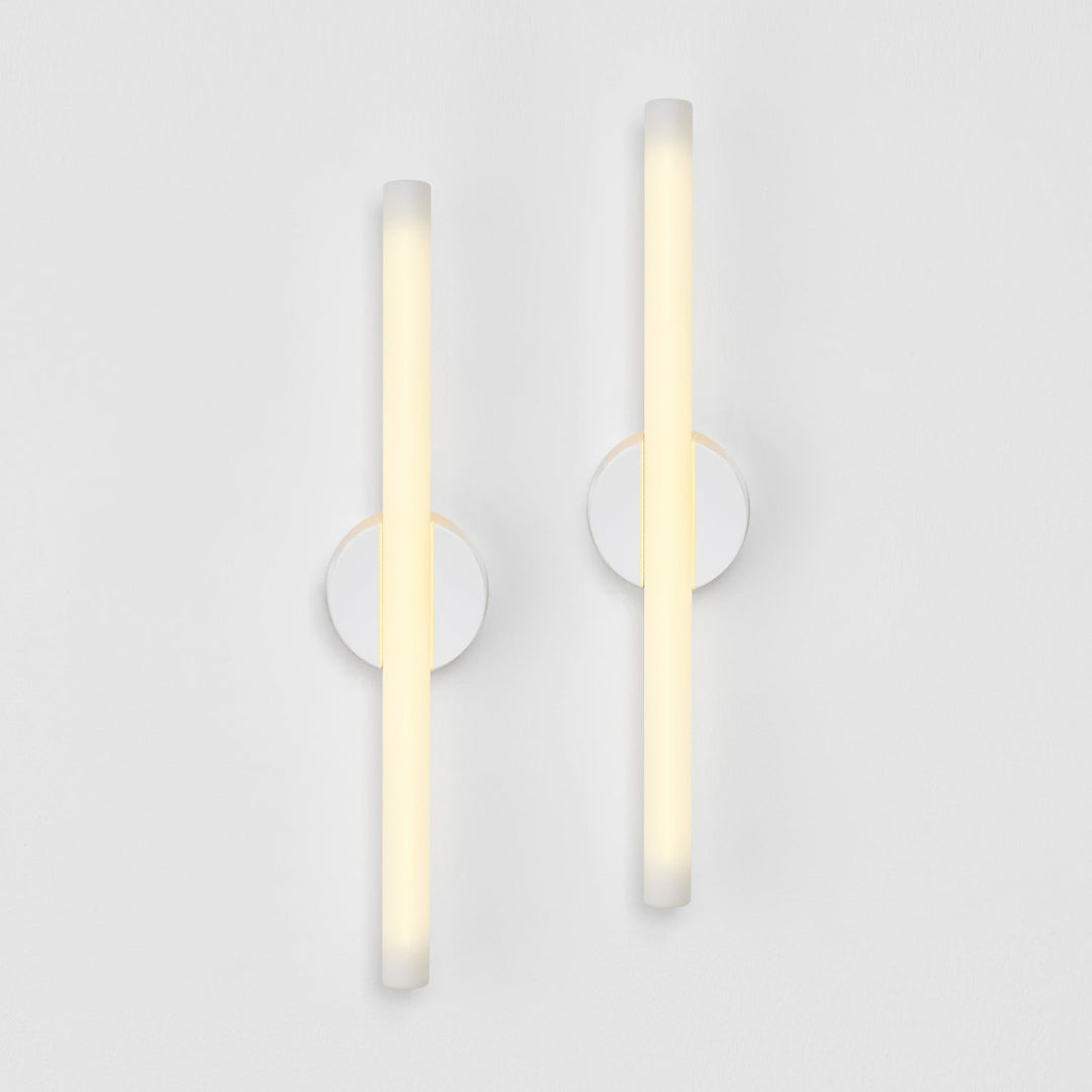 Modern frosted glass wall sconces with minimalist circular mounts, elegant ambient lighting design