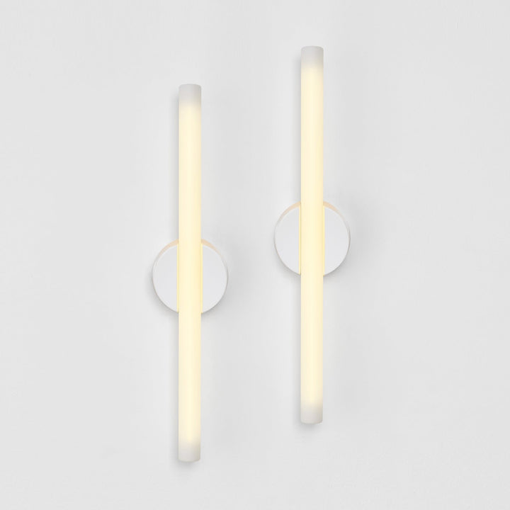 Modern frosted glass wall sconces with minimalist circular mounts, elegant ambient lighting design