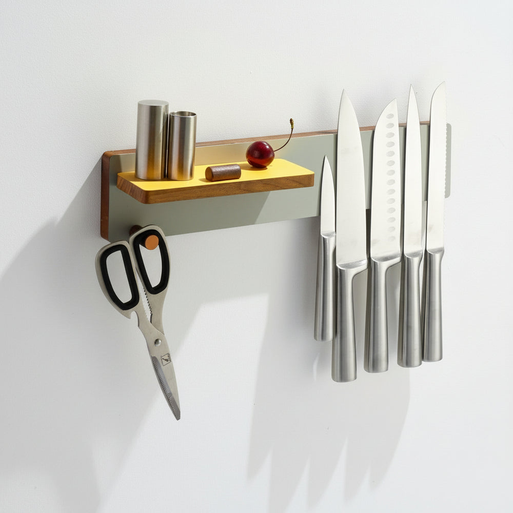 Modern magnetic knife rack in stainless steel and wood, holding knives and kitchen tools