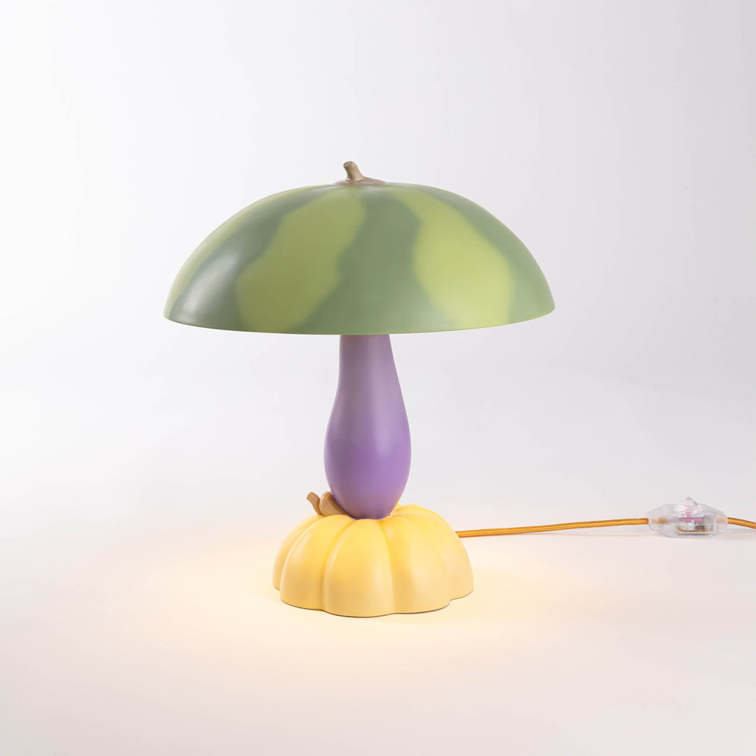 Seletti Vitamin Watermelon Table Lamp, the watermelon lamp glowing warm on a pale backdrop