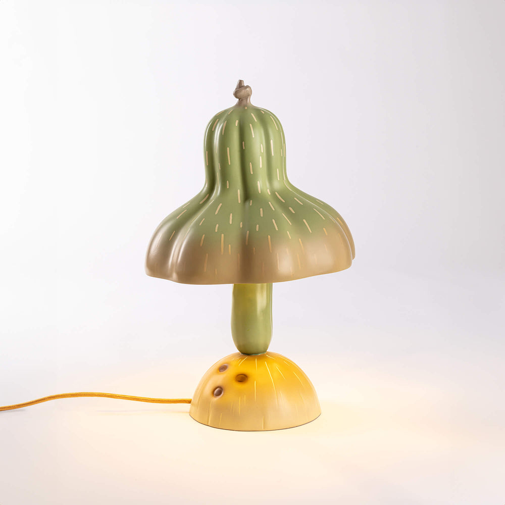 Seletti Vitamin Pumpkin Table Lamp, the gourd lamp lit on a pale backdrop