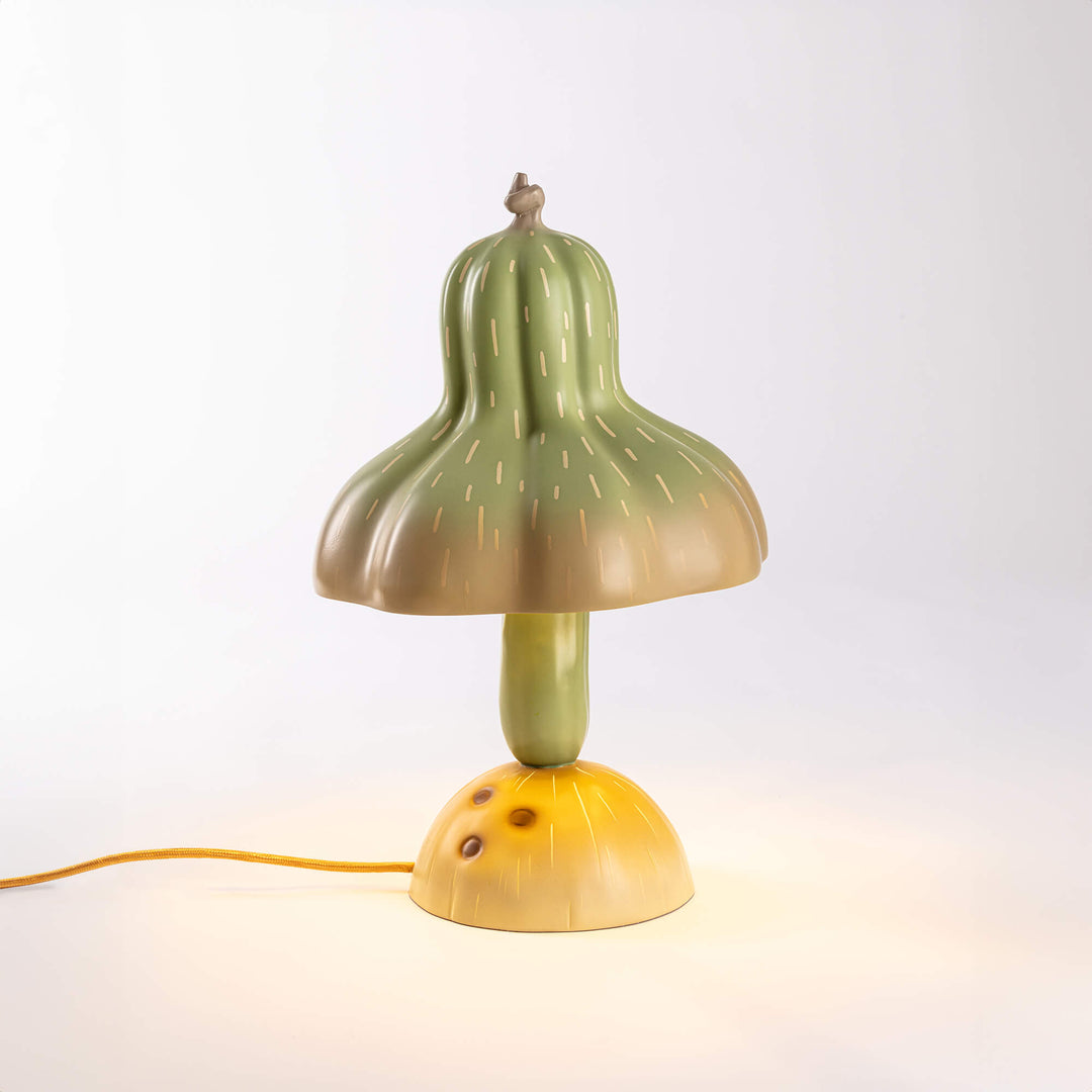 Seletti Vitamin Pumpkin Table Lamp, the gourd lamp lit on a pale backdrop