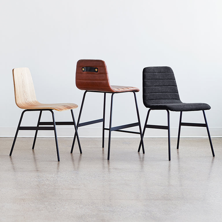 Modern chairs in wood, leather, and fabric with sleek metal legs, curated for elegant interiors.