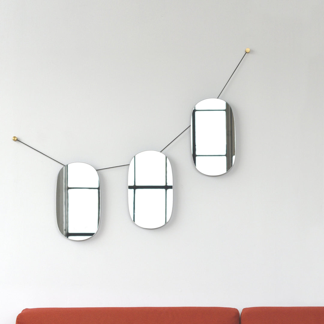 Modern oval mirrors with brass accents, minimalist wall decor