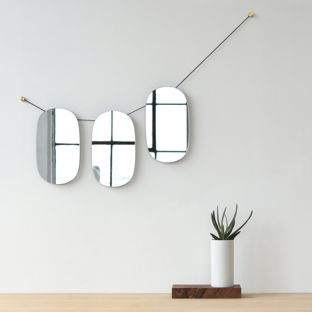 Modern oval mirrors with brass accents, minimalist wall decor