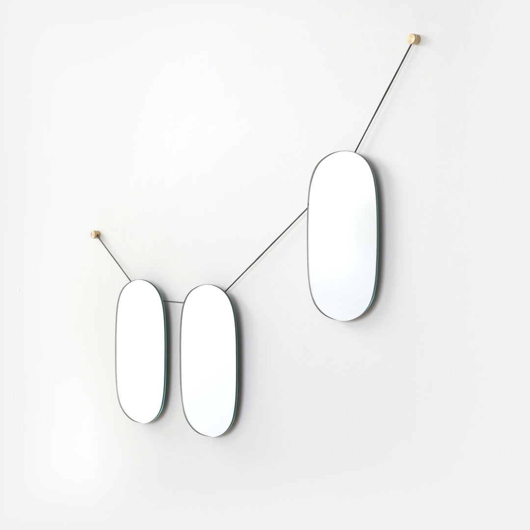 Elegant oval mirrors with brass mounts, minimalist modern wall decor