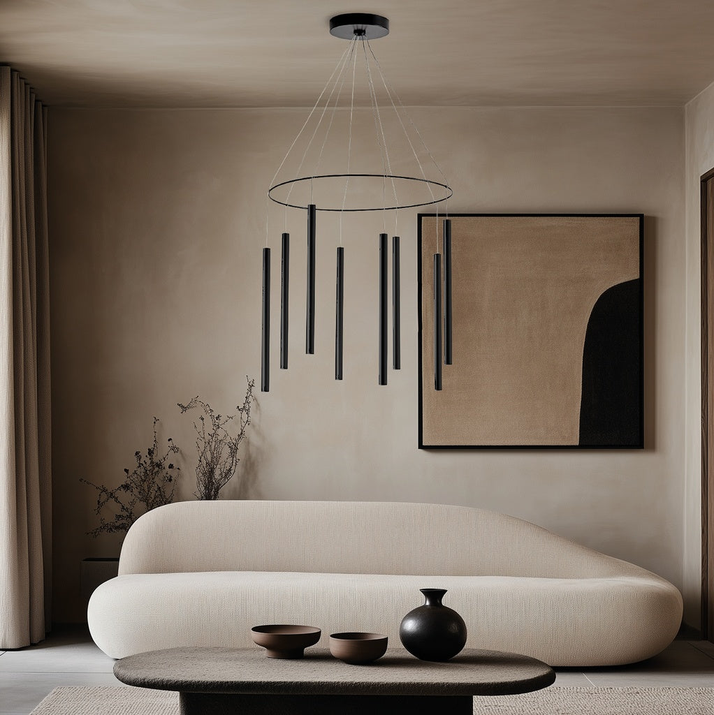 Mika Chandelier in black above a curved cream sofa with abstract artwork and low table